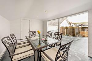 a dining room with a glass table and chairs at 3 Bed in Woolacombe oc-clevel in Woolacombe