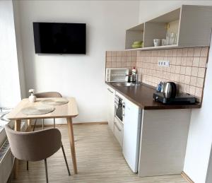 a small kitchen with a small table and a small kitchen with a small table at ZOOM Apartments - Budapest in Budapest