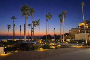 a view of a resort with palm trees at night at Hotel Punta Bermeja Premium in El Puerto de Santa María
