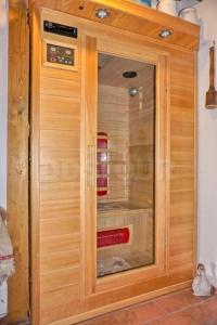 a wooden cabinet with a glass door in a kitchen at Chalupa Dolní Hedeč blízko Dolní Moravy in Horní Orlice +43 photos