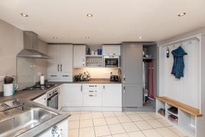 a kitchen with white cabinets and a sink at 2 Bed in Braunton oc-stabb in Braunton