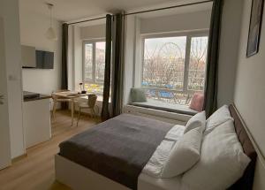 a bedroom with a bed and a window and a table at ZOOM Apartments - Budapest in Budapest