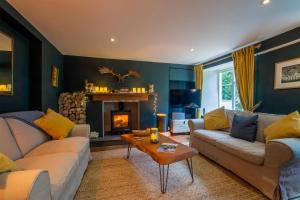 a living room with two couches and a fireplace at 2 Bed in Lynton oc-trelyn in Lynmouth