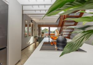 a living room with a staircase in a house at Via Positano 95, Paulshof in Sandton