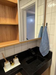 a bathroom counter with a sink and a mirror at Casa Matteucci 2 quartos in Londrina +39 photos