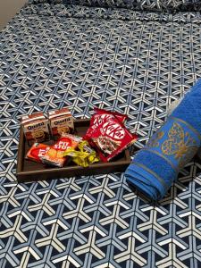 a tray of snacks and a pillow on a bed at Casa Matteucci 2 quartos in Londrina
