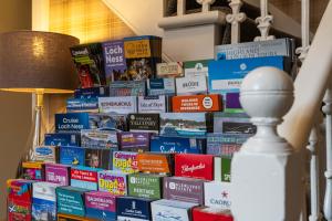 a pile of books stacked on top of each other at mySTAYINN Strathblane House in Inverness