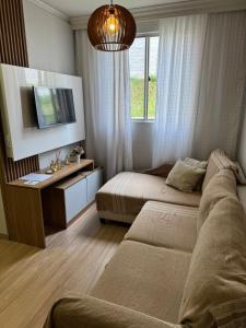 a bedroom with two beds and a television in it at Casa Matteucci 2 quartos in Londrina