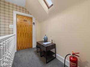 a room with a wooden door and a table at mySTAYINN Strathblane House in Inverness