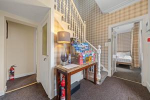 a hallway with a table with drinks on it at mySTAYINN Strathblane House in Inverness