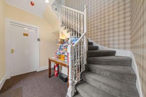 a staircase in a home with a stair case at mySTAYINN Strathblane House in Inverness