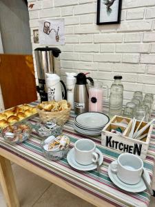 a table topped with plates and cups of coffee and pastries at Hotel Riviera in Santa Teresita +6 photos