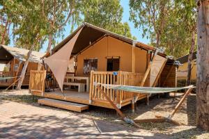 a house with a hammock in front of it at Glamping at Sardinia in Alghero