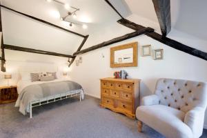 a bedroom with a bed and a chair at 1 Bed in Parracombe oc-smitho in Trentishoe