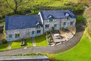 an aerial view of a stone house with a blue roof at 1 Bed in Parracombe oc-smitho in Trentishoe