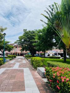 a walkway in a park with flowers and trees at Hotel Doña Mary Huatulco in Santa Cruz Huatulco