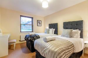 a bedroom with two beds and a window at Hillbrook House 4- Malvern in Great Malvern