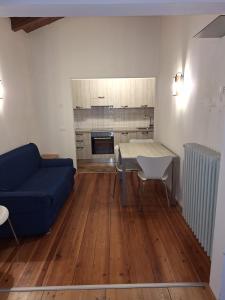 a living room with a blue couch and a table at Chalet Luisa in Cima Gogna +6 photos