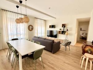a living room with a table and a couch at Espacios Blanco Santiago in Valladolid
