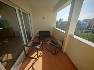 two chairs sitting in a room with two windows at Buzios Praia da Rocha in Portimão