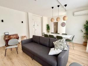 a living room with a couch and a table at Espacios Blanco Santiago in Valladolid