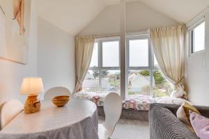a living room with a table and a large window at 2 Bed in Croyde oc-bolt in Croyde
