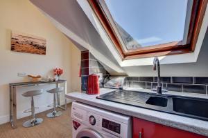 a kitchen with a sink and a window at 2 Bed in Croyde oc-bolt in Croyde +14 photos