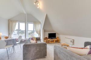a living room with two couches and a tv at 2 Bed in Croyde oc-bolt in Croyde