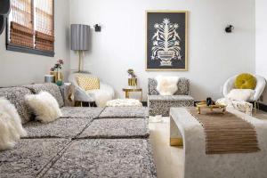 a living room with a couch and a table and chairs at Boho Lux in Atlanta