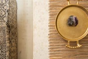a gold mirror with a stone on a table at Boho Lux in Atlanta