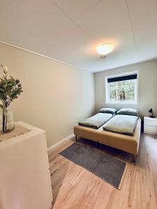 a bedroom with a bed and a window at Kvitefjell 35 in Loen