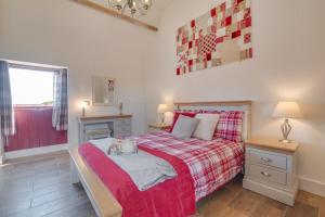 a bedroom with a bed with a red blanket and a window at 2 Bed in Saltburn-by-the-sea oc-wa021 in Easington