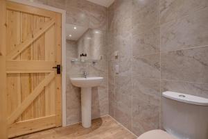 a bathroom with a toilet and a sink and a door at 2 Bed in Saltburn-by-the-sea oc-wa021 in Easington +17 photos