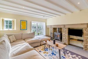 a living room with a couch and a fireplace at 3 Bed in Askrigg oc-ds958 in Askrigg