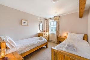 a bedroom with two beds and a window at 3 Bed in Askrigg oc-ds958 in Askrigg
