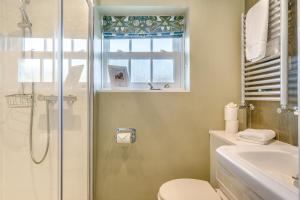 a bathroom with a shower and a toilet and a sink at 3 Bed in Askrigg oc-ds958 in Askrigg +20 photos