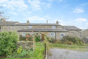 an old stone house with a garden in front of it at 3 Bed in Askrigg oc-ds958 in Askrigg