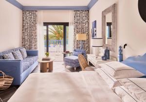 a bedroom with a bed and a couch and a table at Seaside Los Jameos in Puerto del Carmen +37 photos
