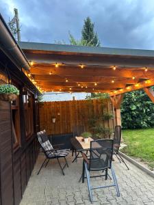 a patio with a table and chairs under a pergola at Ferienhaus "Oybinblick" in Oybin +3 photos