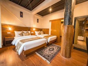 a bedroom with two beds in a room at Hotel Ambrosia in Gangtok