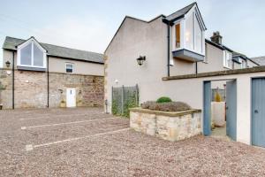 a house with a parking lot in front of it at 2 Bed in Bamburgh oc-gd1165 in Bamburgh