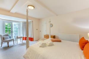 a bedroom with a large white bed and a desk at 2 Bed in Bamburgh oc-gd1165 in Bamburgh