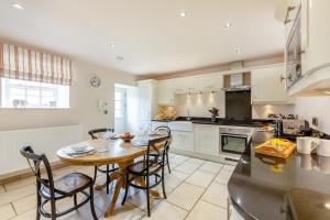 a kitchen with a table and chairs in a kitchen at 2 Bed in Bamburgh oc-gd1165 in Bamburgh