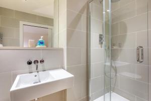a white bathroom with a sink and a shower at 2 Bed in Bamburgh oc-gd1165 in Bamburgh +25 photos