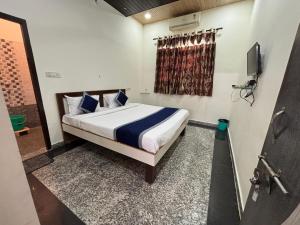 a bedroom with a bed and a window and a television at Hotel Star Inn , Pushkar in Pushkar