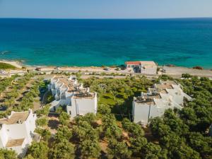 an aerial view of a row of white buildings next to the ocean at Fata Morgana Studios & Apartments in Frangokastello +71 photos