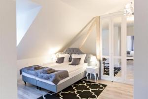 a bedroom with a king sized bed and a staircase at Mazurski Diament koło Mrągowa in Sorkwity +78 photos