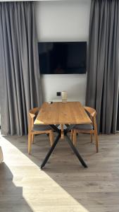 a wooden table and a pair of wooden chairs at Bavaro apartments 2 in Ivano-Frankivsk +12 photos