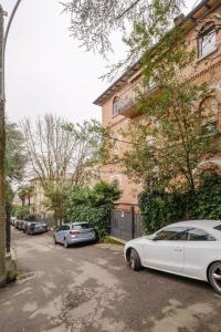a white car parked in front of a building at A Casa Gualandi in Bologna