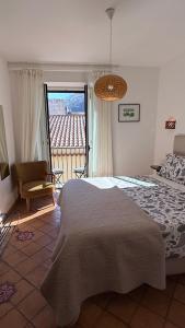 a bedroom with a large bed and a balcony at Agrodolce B&B in Cefalù
